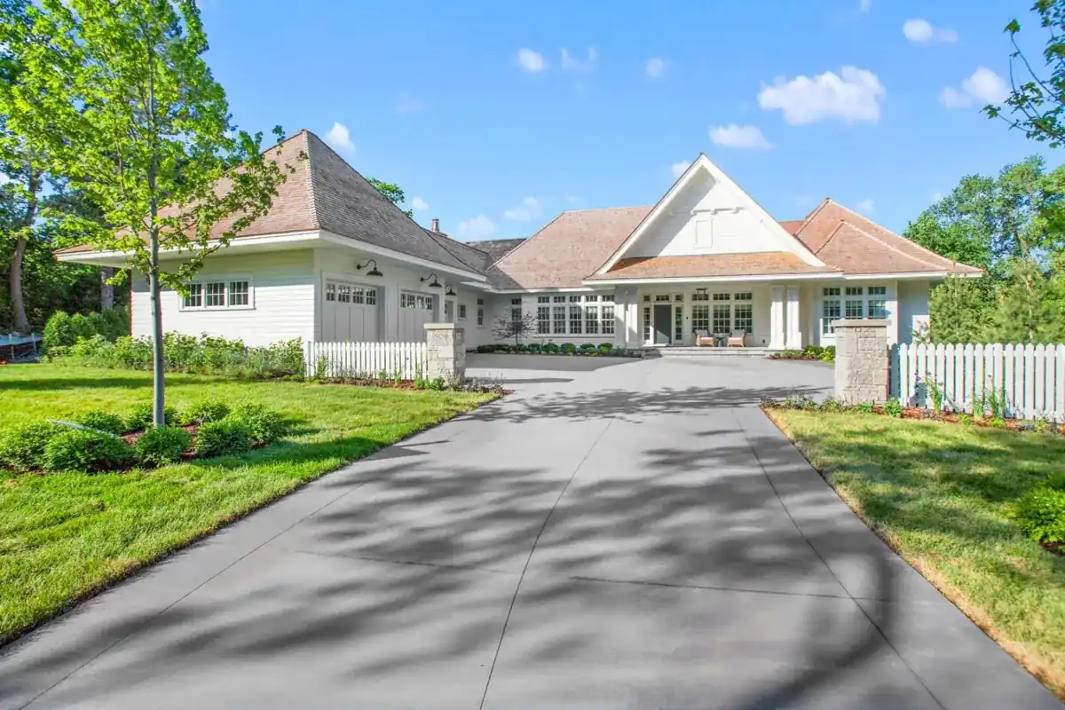 long concrete driveway curving through a shaded lawn to a home in Royal Palm Beach