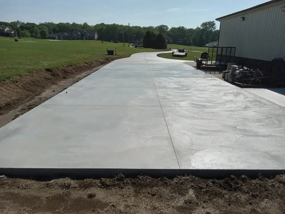 long concrete slab and apron beside a metal building on open land in Royal Palm Beach