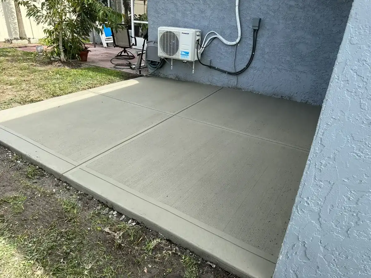 new concrete slab beside a house wall with jointed panels in Royal Palm Beach